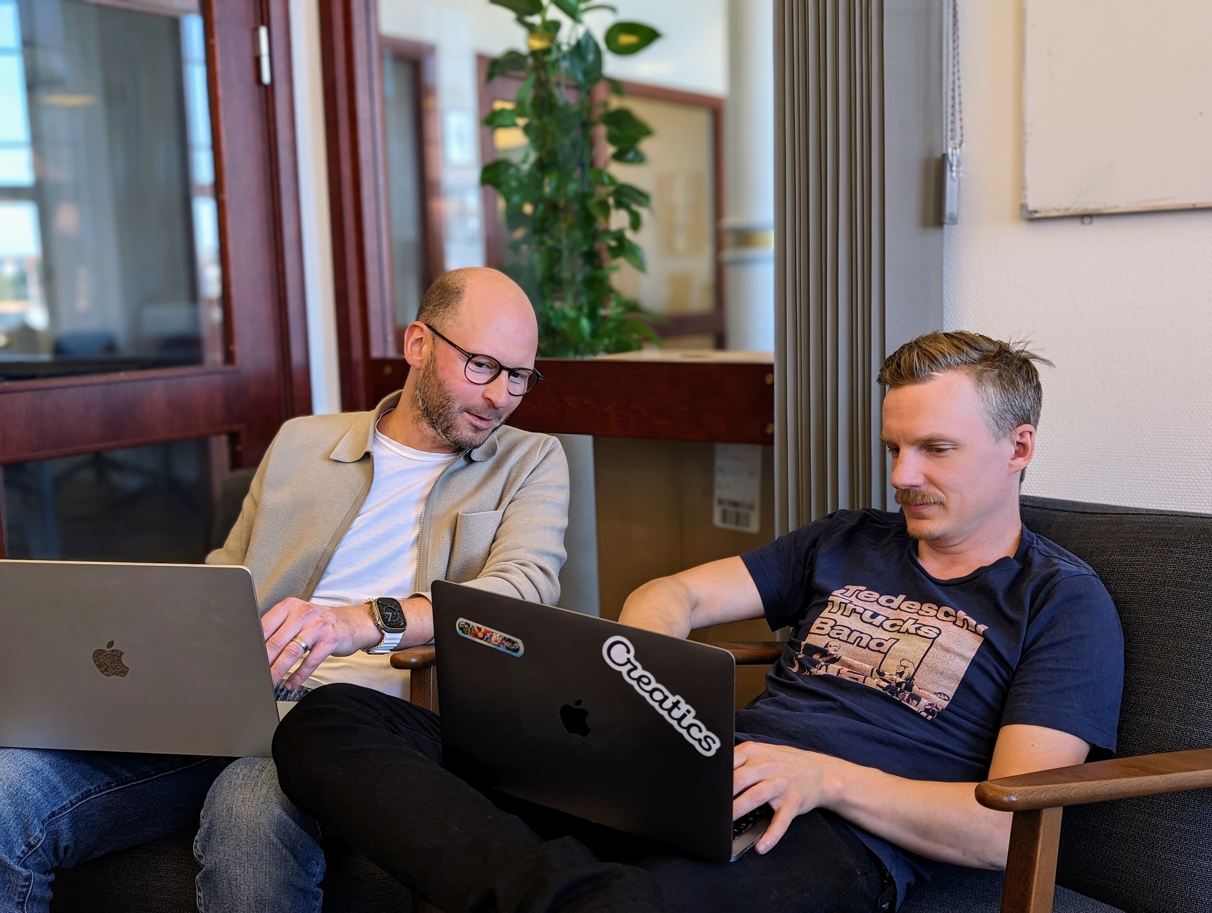 two co-workers sitting in side by side